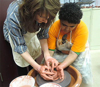 Teacher and student working at potters wheel - Special Education, Bloomfield NJ