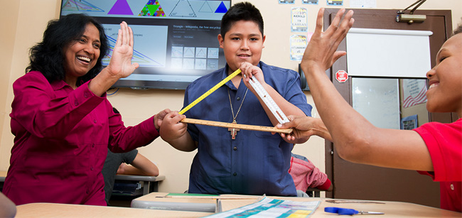 Teacher with two students high fiving in math class - Special Education, Bloomfield NJ