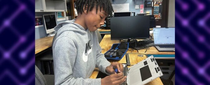 Westbridge student working on a piece of computer hardware